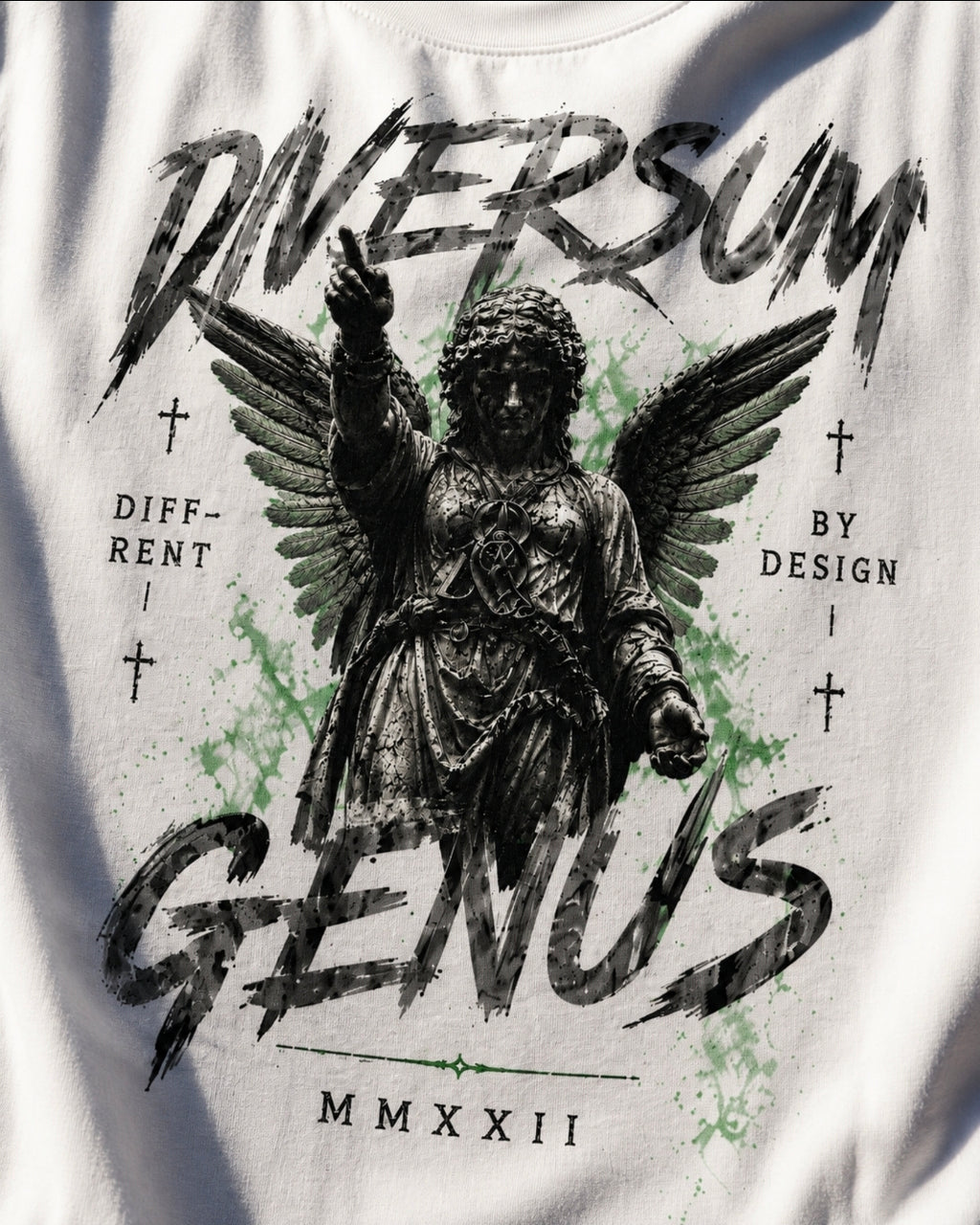 White graphic t-shirt featuring a distressed black illustration of an angel with wings and the text 'DIVERSUM GENUS' with 'MMXXII' below, accented with light green paint splatters.